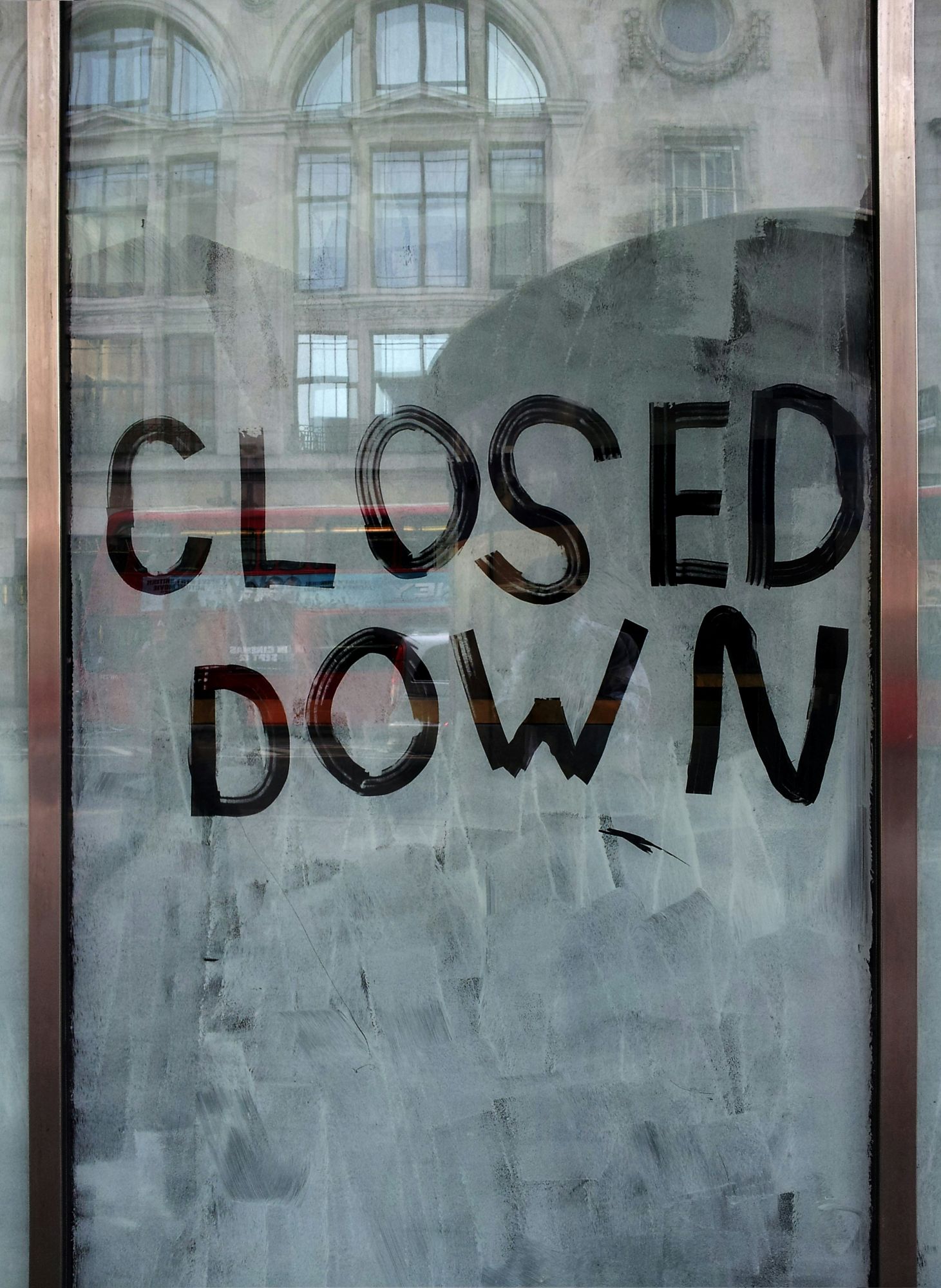 blurred window close up with Closed Down written on it