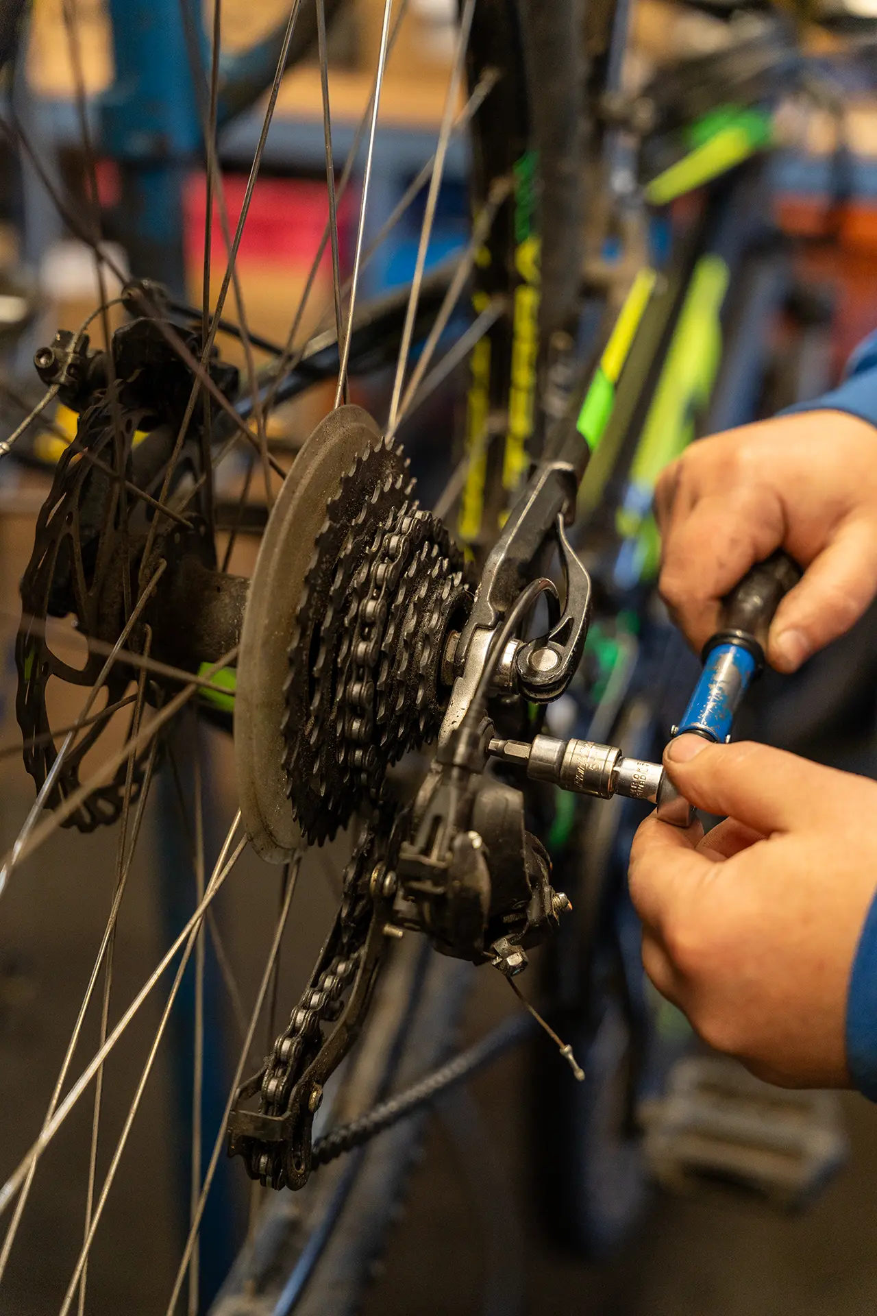 hand holding tool to service a rear mech on bicycle